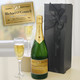 Personalised Happy Birthday Champagne. A bottle of champagne labeled "Michael O’Connell" with a gold label celebrating a 50th birthday, placed next to two flutes filled with champagne. The bottle is surrounded by a black gift box adorned with a bow and a label insert that reads "Happy 50th Birthday." Personalised Happy Birthday Champagne. A bottle of champagne labeled "Michael O’Connell" with a gold label celebrating a 50th birthday, placed next to two flutes filled with champagne. The bottle is surrounded by a black gift box adorned with a bow and a label insert that reads "Happy 50th Birthday."
